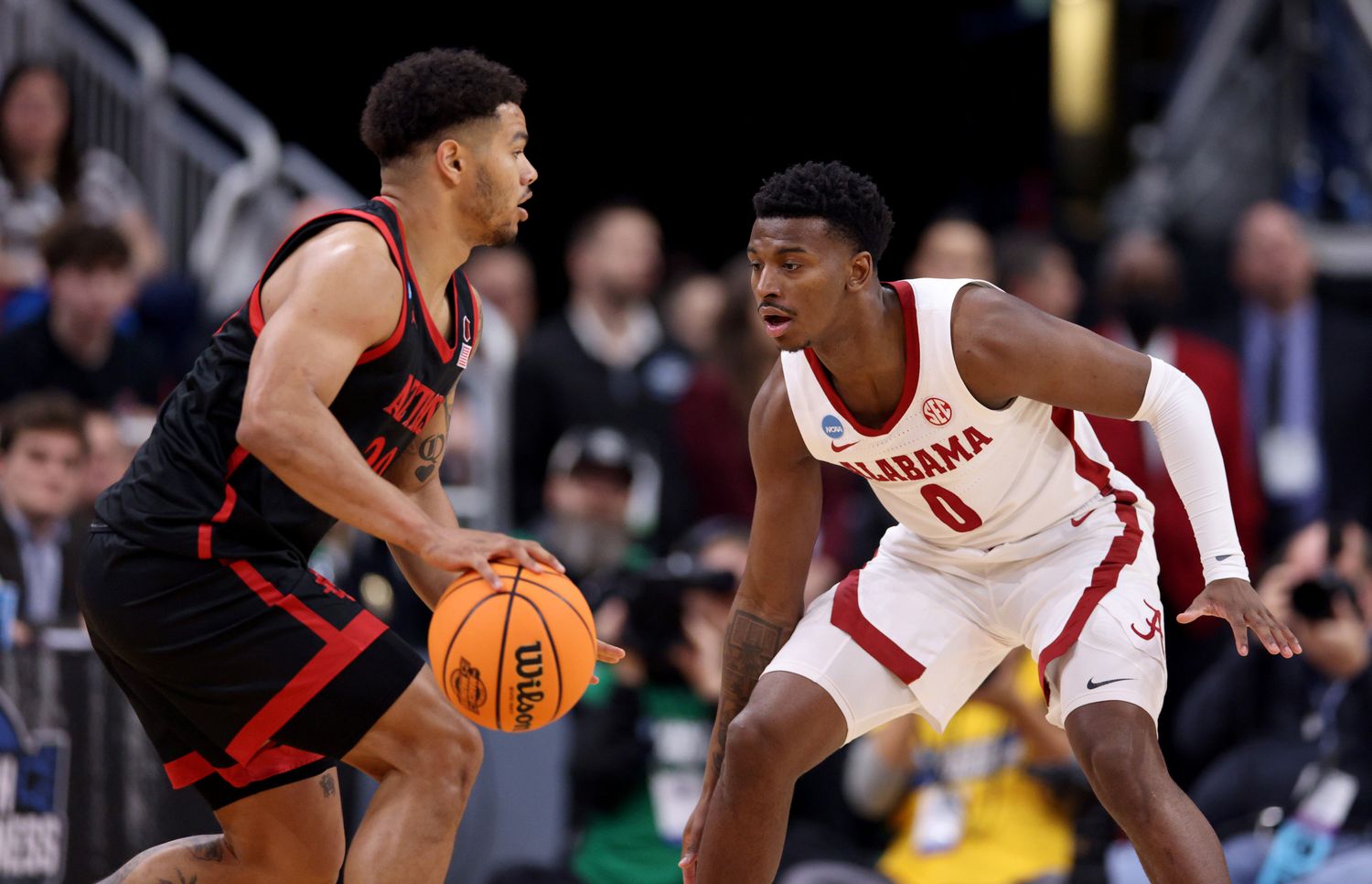 San Diego State Aztecs guard Matt Bradley (20) dribbles against Alabama Crimson Tide guard Jaden Bradley (0) during the first half of the NCAA tournament round of sixteen at KFC YUM! Center.
